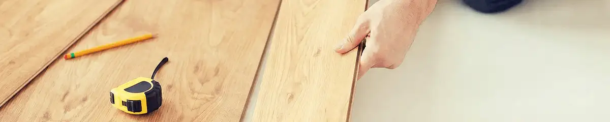 A professional installing wood flooring in Eugene, OR