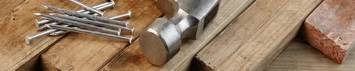 Hammer and nails on hardwood flooring boards in Eugene, OR