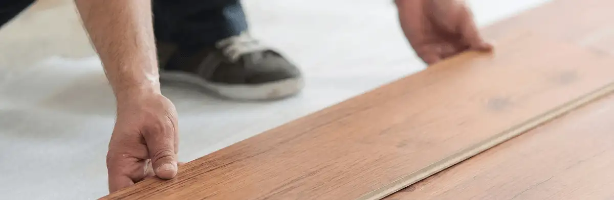 A professional installing laminate flooring in Eugene, OR